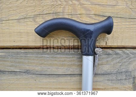 Close-up Of A Walking Stick On A Wooden Background.