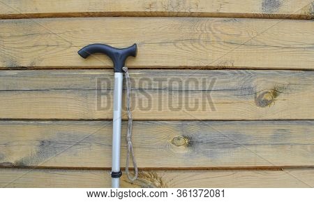 Close-up Of A Walking Stick On A Wooden Background.