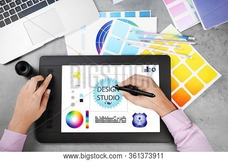Top View Of Professional Female Designer Working With Graphic Tablet At Grey Stone Desk, Closeup