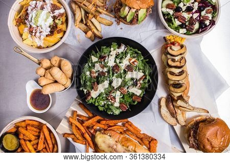 Set With Dishes From Spanish Bar Nachos, Salad, Tequenos, Hotdog, Potato, Burger