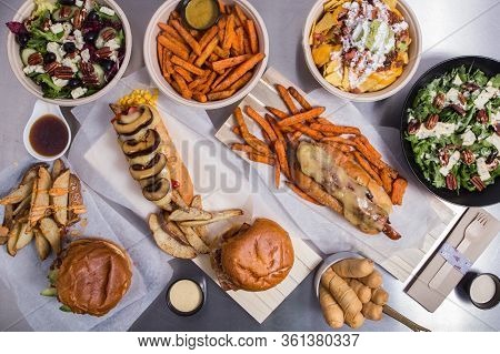 Set With Dishes From Spanish Bar Nachos, Salad, Tequenos, Hotdog, Potato, Burger