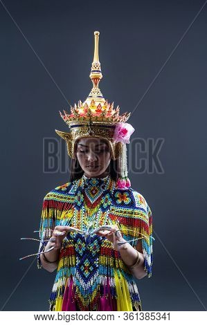 Young Lady Wearing Thai Tradition Southern Costume ,made From Colorful Beads,put Headdress On Her He