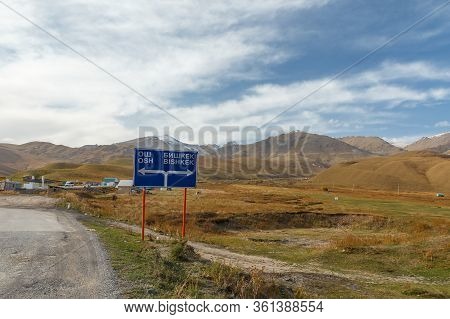 A Traffic Sign Indicating The Direction To Bishkek And Osh In The Suusamyr Valley In Kyrgyzstan.