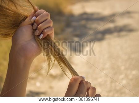 Girl Holding Dry Brittle Hair. Brittle Damaged Tips, Hair Loss.