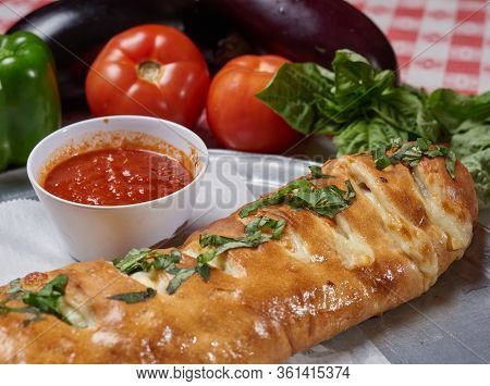 Fresh Stromboli Served With Tomato Sauce And Vegidables