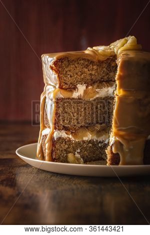Birthday Cake Interior With Sponge Cake Layers, Yogurt Filling, And Apples, With Caramel Glaze. Slic
