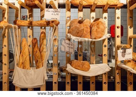 Inside View Of An Italian Bakery Shop With The Kitchen In Background And Different Bread Types: Pan 