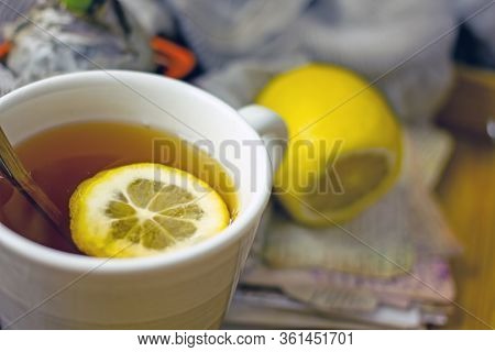 Hot Black Tea With A Slice Of Lemon In A Large Gray Mug With A Spoon Closeup, Top View, Next To A Fr
