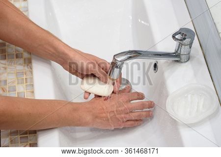 A Man Provides First Aid For Cutting His Hands, Washing The Wound With Soap
