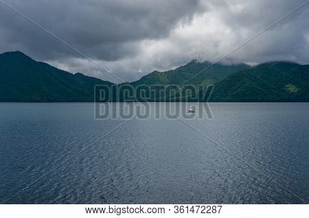 Mountain Lake Landscape With Fishing Or Cruise Boat. Lake Chuzenji In Chugushi, Japan