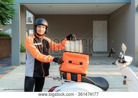 Delivery Asian Man Wearing Orange Uniform And Ready To Send Delivering Food Bag In Front Of Customer