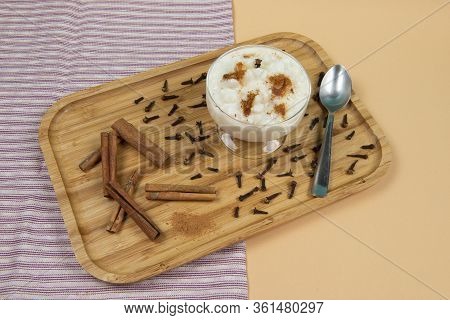 Traditional
Bowl Of Hominy (canjica) On A Wooden Tray, Typical Brazilian Food At The June Festivals