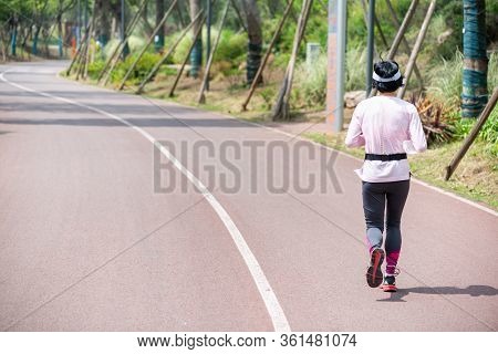 Chengdu, Sichuan Province, China - Apri 14, 2020 : Woman Running On Tianfu Greenway Rear View