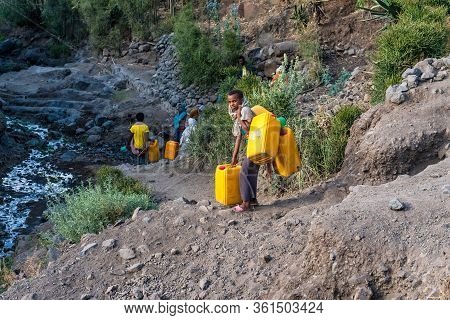 Lalibela, Ethiopia - Feb 12, 2020: People Getting Water At A Water Point In Lalibela, Ethiopia. Afri