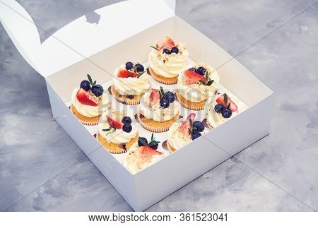 Set Of Different Delicious Cupcakes. Paper Box With Fruit Cupcakes. Holiday Cupcakes With Strawberry