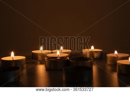 Candles Lit In The Dark, And One Candle Unlit, Sad And Tragic Scene