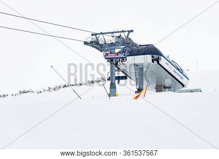 Snowy Ski Slopes And Chair Ski Lifts Station In  Mountain Ski Resort.