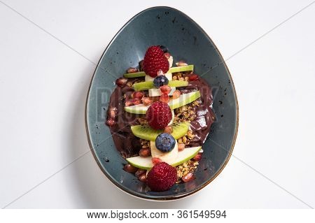 Acai Cerry Smoothie Bowl Topped With Raspberries, Bananas And Blueberries