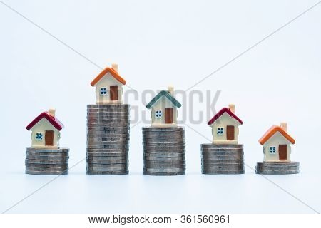 Mini House On Stack Of Coins On  White Background, Money And House,  Mortgage, Savings Money For Buy