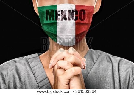 Praying for Mexico. Coronavirus pandemic outbreak. Doctor praying for help. Young woman medical doctor surgeon or nurse wearing mask with mexican flag and text background.