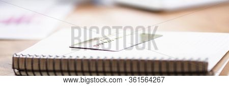 Table In Bank Notepad With Spring And Credit Card. Transfer Cash To Bank Account. Analysis Expenses 
