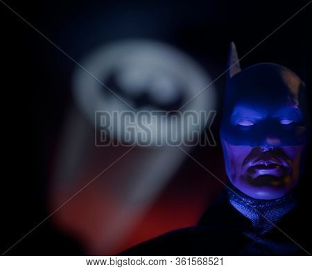 APRIL 15 2020:  Portrait of crime fighter Batman with the bat signal over Gotham City - Mego Corp. action figure