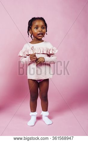 Little Cute African Girl Posing Cheerful Inocent On Pink Background, Lifestyle People Concept