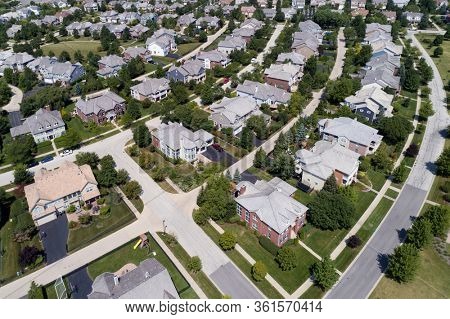 Aerial view of a tree-lined neighborhood in a Chicago suburban city in summer.