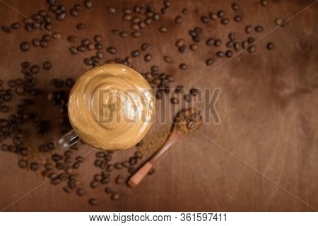 Cold Dalgona Coffee In Clear Glasses On A Dark Wooden Background. Froth Of Sugar And Instant Coffee
