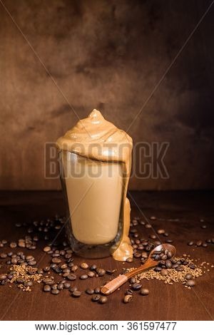 Cold Dalgona Coffee In Clear Glasses On A Dark Wooden Background. Froth Of Sugar And Instant Coffee
