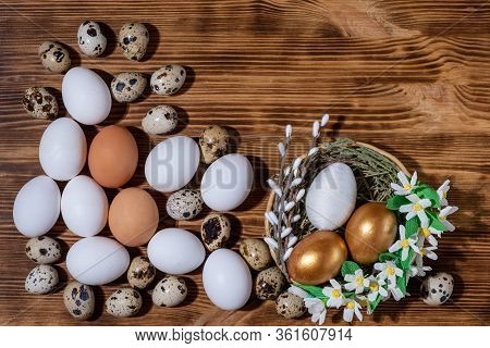 Easter Eggs In Basket Filled With Straw And Yellow Flowers And Willow On Wooden Rustic Vintage Backg