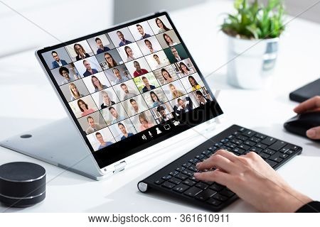 Man Working From Home Having Online Group Videoconference On Laptop