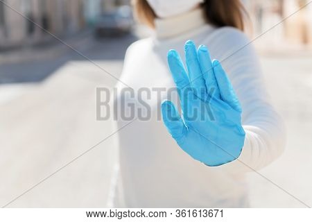 Stay At Home. Covid-19 Quarantine. A Girl In Protective Mask And Gloves Blocks Corona Virus. Social 
