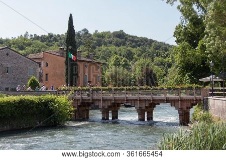 Italy, Valeggio Sul Mincio - May 20 2018: The View Of Wooden Bridge Across The River, Borghetto Vale