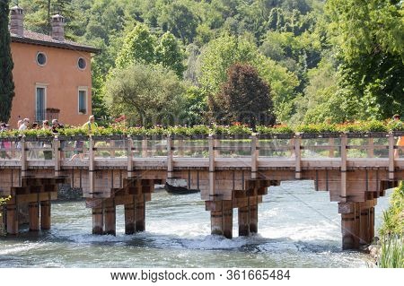 Italy, Valeggio Sul Mincio - May 20 2018: The View Of Wooden Bridge Across The River, Borghetto Vale