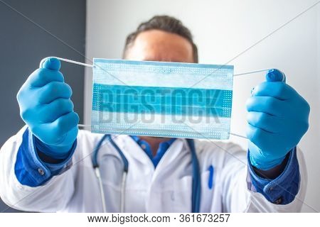 Medical Professional, Scientist Or Doctor Holds Medical Mask In Outstretched Hands Near Front Of Cam