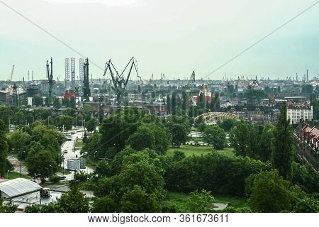 Panorama Of The Gdansk Shipyard With Its Distinctive Cranes And Ships Being Built And Repaired. Also