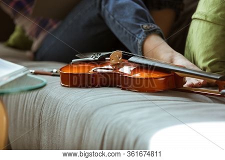Young Woman Studying At Home During Online Courses Or Free Information By Herself. Becomes Musician,