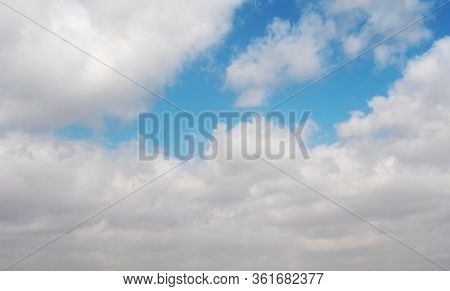 Clouds Swiftly Swim Through The Blue Sky Of The Day