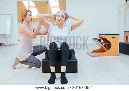 Pilates, Fitness, Sport, Training And People Concept - Woman Doing Exercises On Small Barrel.