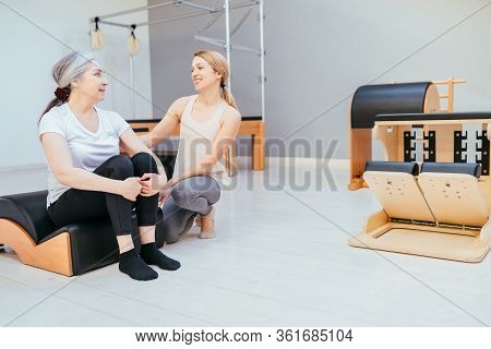 Pilates, Fitness, Sport, Training And People Concept - Woman Doing Exercises On Small Barrel.