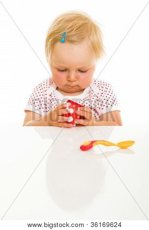 Cute Infant Girl Learining To Eat With Spoon