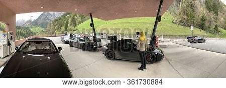 Italy, 28 April 2019: Some Black Sports Cars Refuel At Gas Station Somewhere On Serpentines In The I