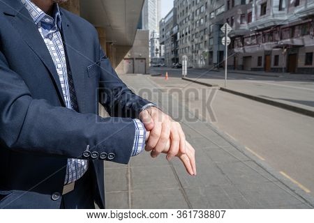 Businessman In A Blue Suit Using Small Portable Antibacterial Sanitizer Applying Antiseptic For Wash