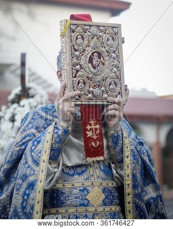 Shallow Depth Of Field (selective Focus) Details With A Romanian Orthodox Christian Priest Holding A