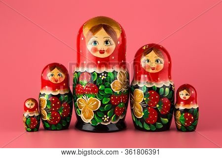 Russian Folk Wooden Doll On A Pink Background