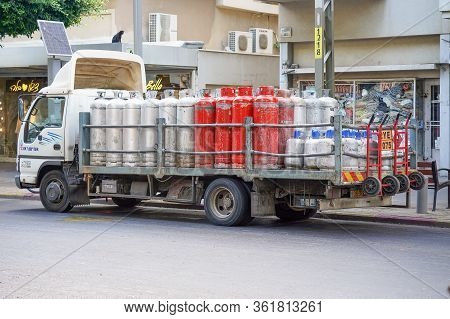 Truck With Gas Cylinders On The Road. Many Red And Gray Gas Cylinders Transported In Car. 19 August 
