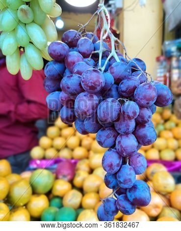 Hanging Bunch Of Grapes In The Fruit Shop.