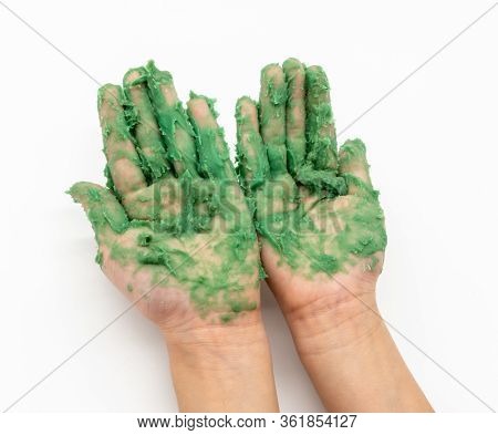 Kid Hand With Green Mudy Play Dough Isolated On White