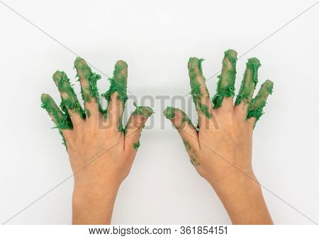 Kid Hand With Green Mudy Play Dough Isolated On White